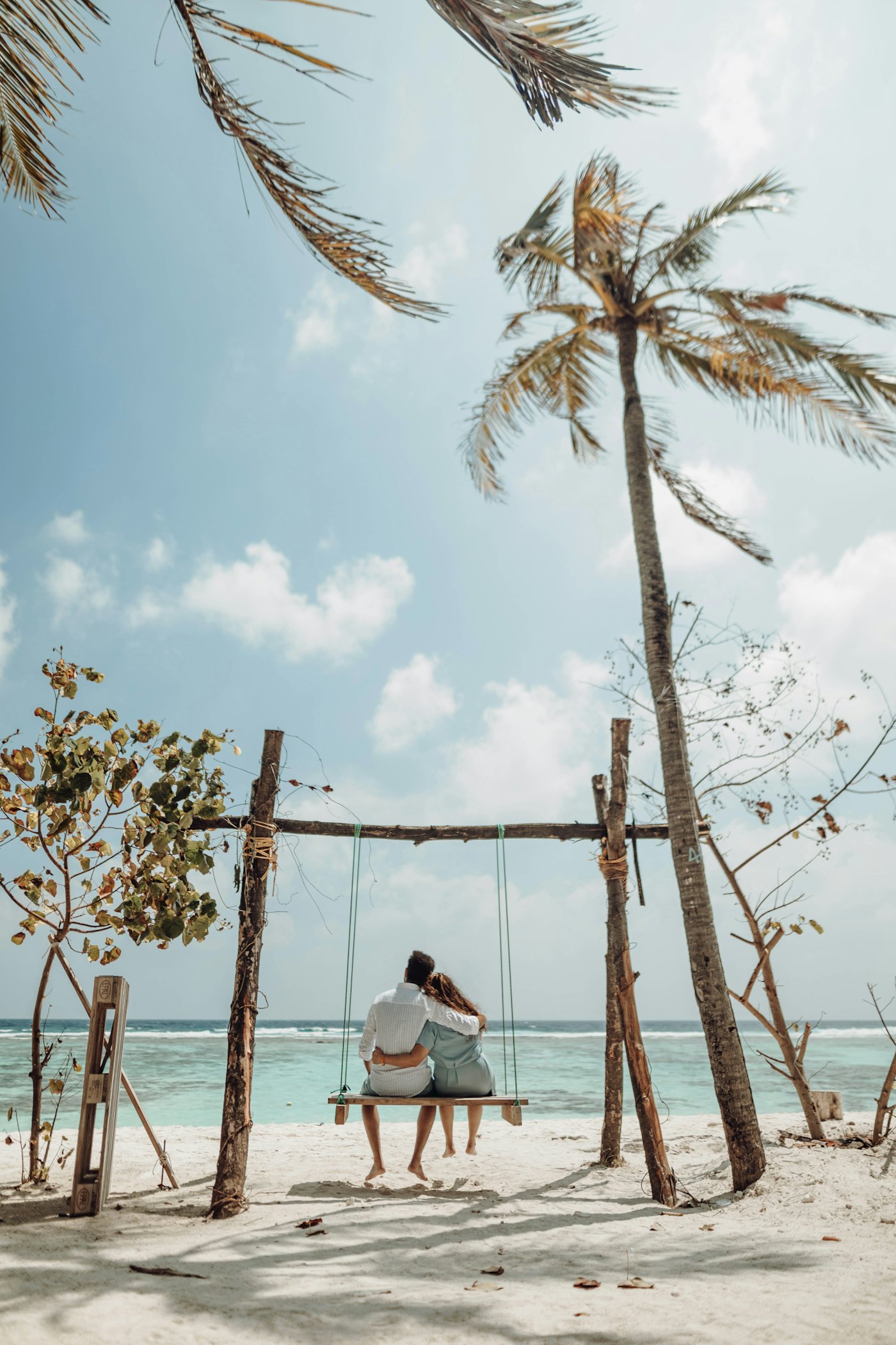 Couple on a bench facing the sea